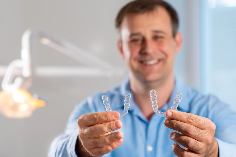 a man showing Invisalign