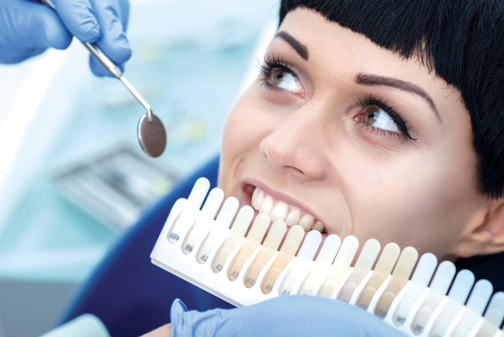 woman sitting in a dental chair while checking the shade