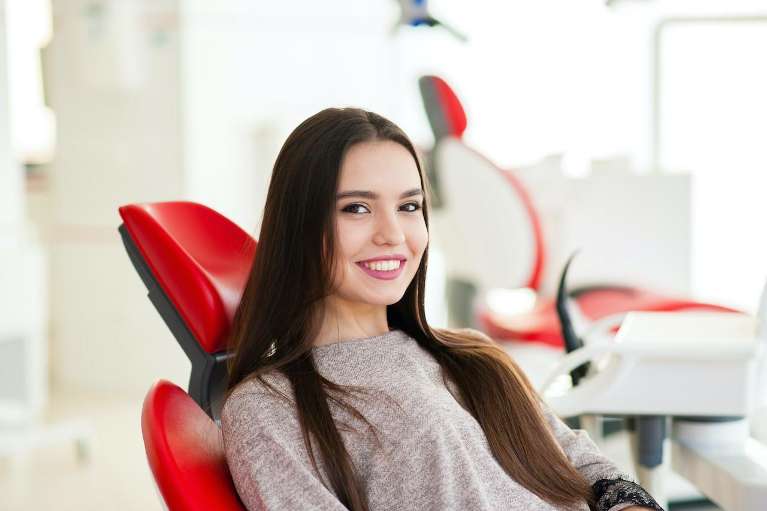 woman smiling after professional teeth whitening in Knoxville, TN