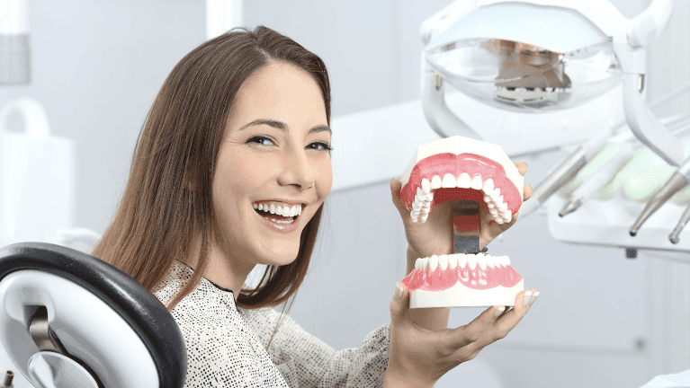 woman holding a teeth illustration